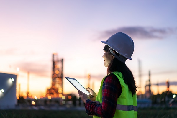 engineer working at night with digital tablet at a construction site